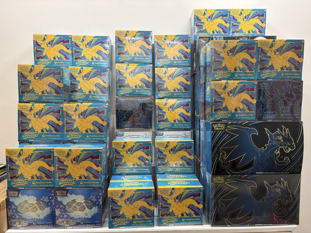 Wall of sealed Pokémon TCG Elite Trainer Boxes and collector products ready for restock monitoring